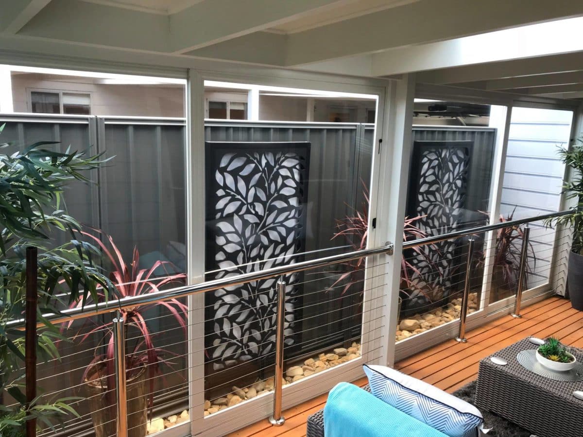 Decorative laser-cut privacy screen detail on a balcony